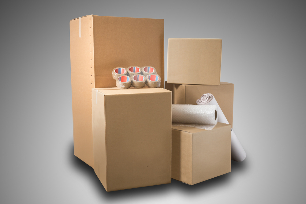 Stack,of,cardboard,boxes,,bubble,wrap,,tape,and,wrapping,paper
