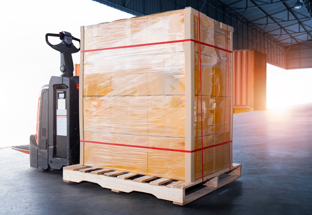 Package,boxes,wrapped,plastic,film,on,pallet,with,electric,forklift