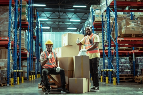 Two,african,american,warehouse,workers,showing,teamwork,and,partnership.,teamwork